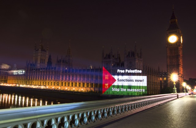 Palestine Solidarity Campaign project image onto the Houses of Parliament calling for'Sanctions Now against Israel and an end to the massacre of Palestinians credit imag